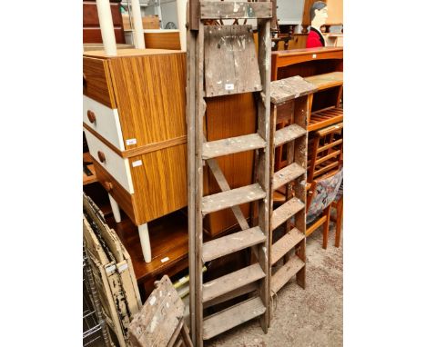 Three sets of wooden step ladders. 