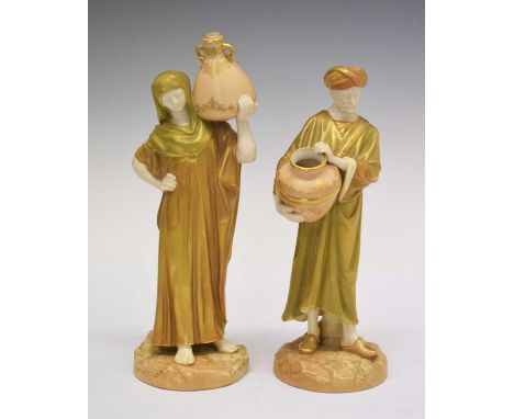 Pair of Royal Worcester James Hadley porcelain shot enamel figures modelled as male and female water carriers, '1250' to base
