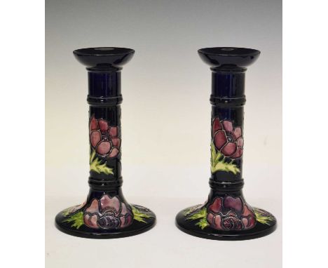 Pair of Moorcroft Anemone pattern candlesticks, each of cylindrical form on spreading base, impressed and painted marks, 21cm