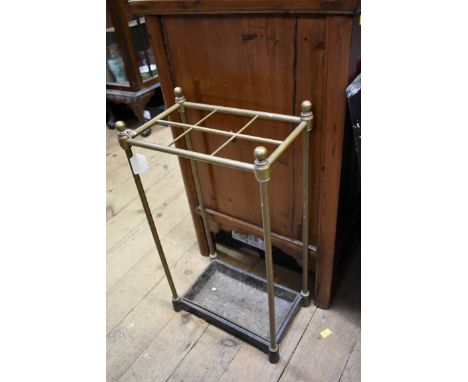 An antique brass six division stick stand, 36cm wide. 