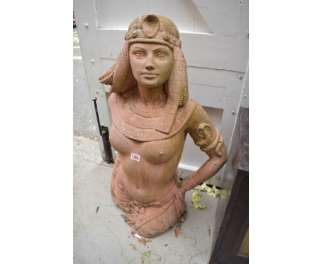 An old red composition stone figure of a semi-nude Egyptian woman, 82cm high, (repairs). 