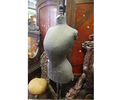 An antique dressmakers dummy on associated ebonized tripod stand.&nbsp; 