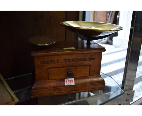 A set of mahogany scales,&nbsp;bearing ivory label inscribed 'S Maw, Son &amp; Thompson...', with apron drawer and seven conc