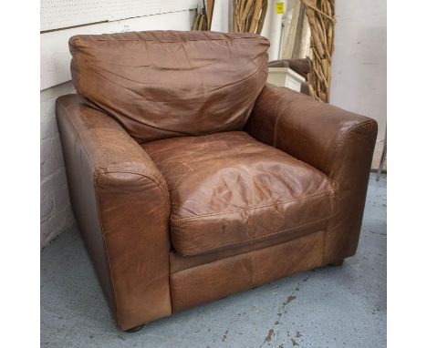 ARMCHAIR, worn brown leather with cushion seat and back, 97cm x 100cm. 