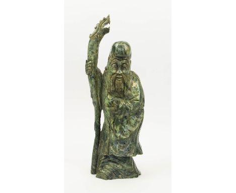 JADE IMMORIAL, depicting Shou Lao, holding a peach and dragon staff, 46cm H. 