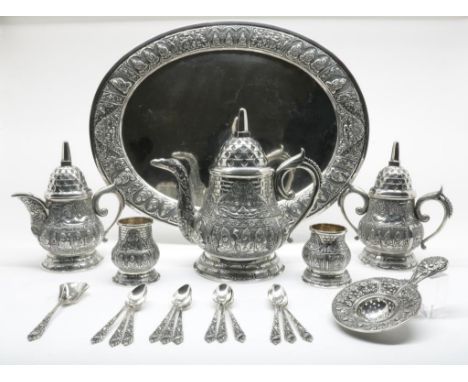 Silver tea service with oval tray, 12 teaspoons and a loose tea  spoon, Indonesia, Yogja, temple pattern with temple guards a