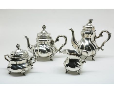 Four piece silver tea and coffee service on leaf feet and twisted  lobbed body with flame finals, retail mark Wilkens,  Breme