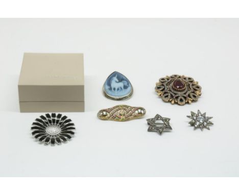 Silver brooche with black enamel 'Daisy', by George Jensen,  925/000, gross w. 16.2 gr., width ca. 4.2 cm. together with five