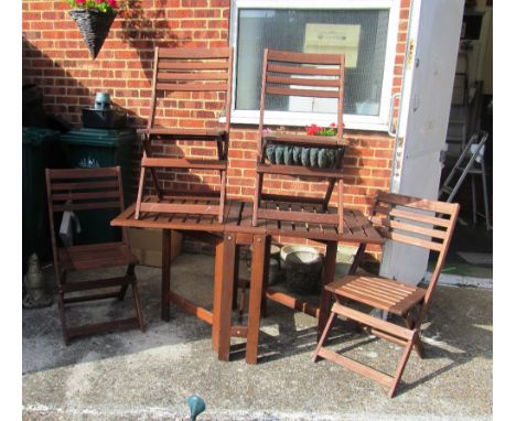 A teak gate leg garden table and four chairs