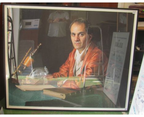 A large photographic historic portrait of a man sitting at a desk with microscope signed indistinctly to reverse and dated 20