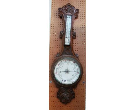 An oak cased barometer/thermometer
