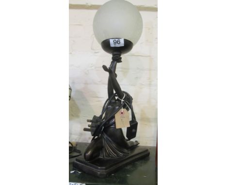 A modern Art Deco style lamp lady holding a globe shade