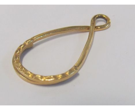 A yellow metal pendant/key ring