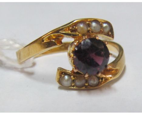 An 18ct gold ring with central purple stone and seed pearls to cross overs 2.7g