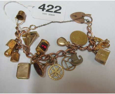 A charm bracelet with 9ct padlock, 9ct gold port light and yacht, other charms and a coin (all at 43g)