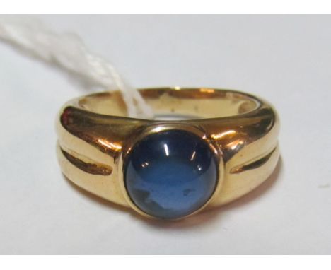 A continental gold coloured ring set circular blue stone (mark on outside of shank) 4.8g