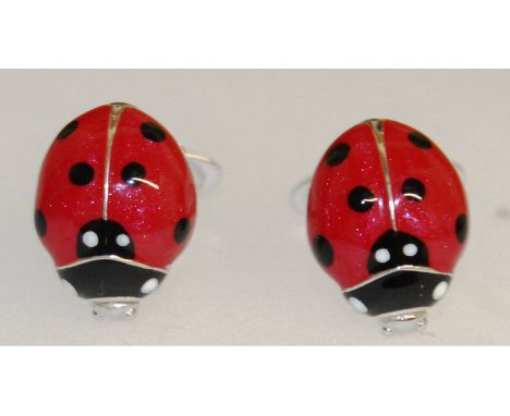 A pair of sterling silver and enamel cufflinks in the form of ladybirds.