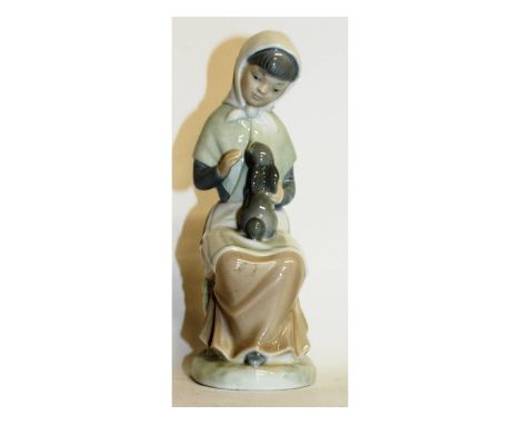 A Nao porcelain figure of a girl with a rabbit. 7.5ins high.