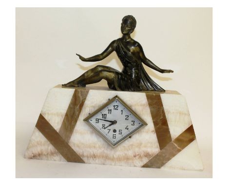 An Art Deco three colour marble cased clock surmounted by a gilded young lady. 19ins long.