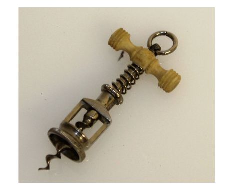 A rare miniature corkscrew, with turned wood handle. 6cms long.
