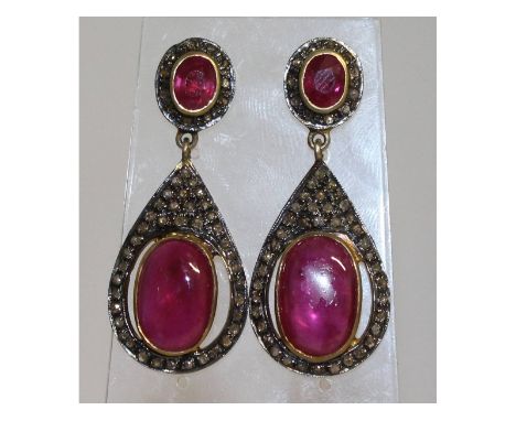 A magnificent pair of cabochon ruby and diamond large drop earrings, set in gold and silver.