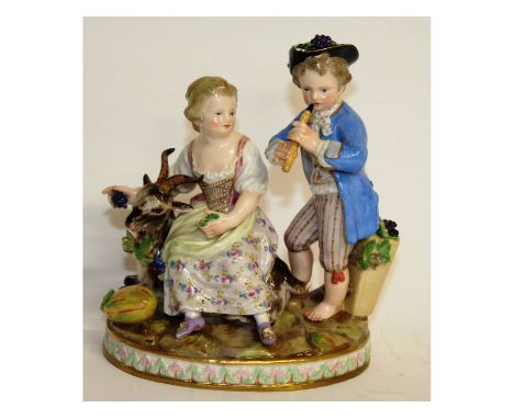 A Meissen group of a young boy playing a recorder, the girl seated at his side with a goat. Cross swords mark in blue. Incise