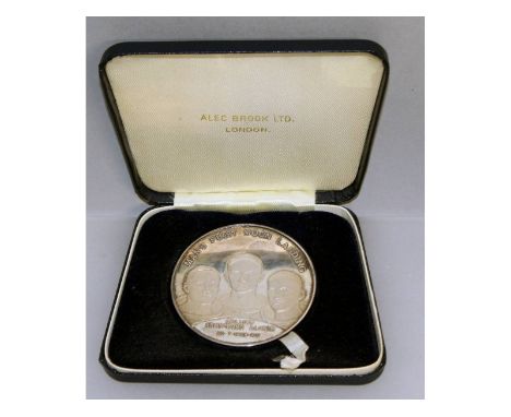 A silver medallion "Mans First Landing on the Moon", No. 2363, in a case.