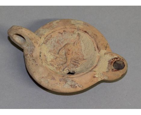A Roman terracotta oil lamp. 4ins long.