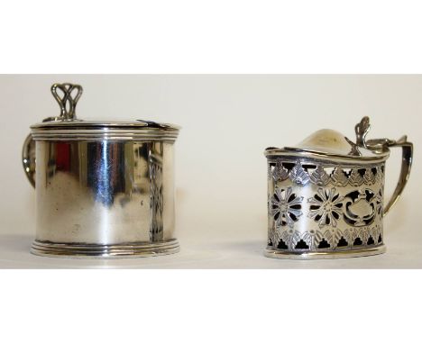 A circular drum mustard pot with sapphire blue liner, London 1929, and an oval pierced mustard pot, Birmingham 1899 (2).