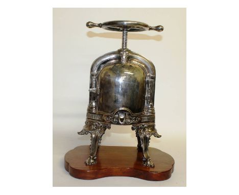 A rare heavy plated "duck" press with screw top, opening front on four curving legs with wooden base. 21ins high.
