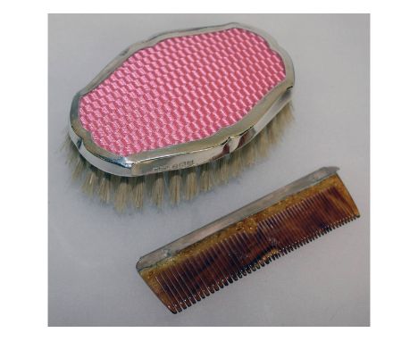 A travelling set with silver back brush and a comb.