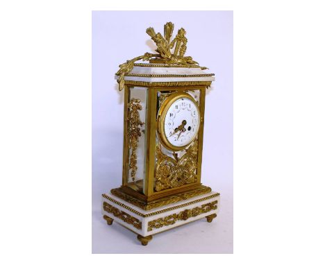 A good Louis XVI white marble and ormolu clock, with eight day movement striking a single bell, the case with rich ormolu mou