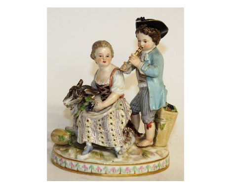 A Meissen group of a young boy playing a recorder, the girl seated at his side with a goat. Cross swords mark in blue. Incise