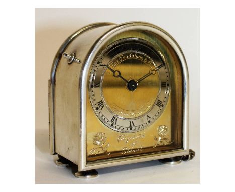 A small Charles Frodsham silver cased clock, with domed top, gilt dial, on four bun feet. 8cms high. London 1980.