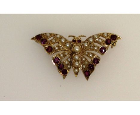 A ruby and seed pearl butterfly brooch.