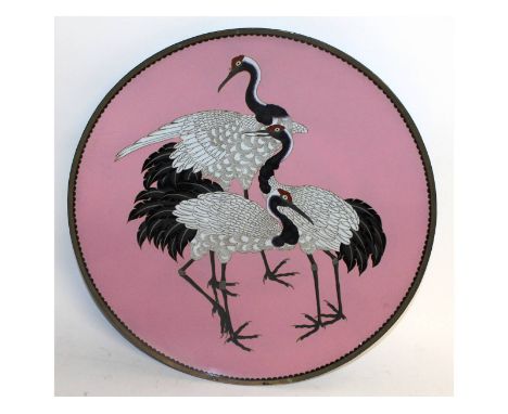 A large Japanese cloisonne enamel circular plaque, decorated with three storks. 18ins diameter.