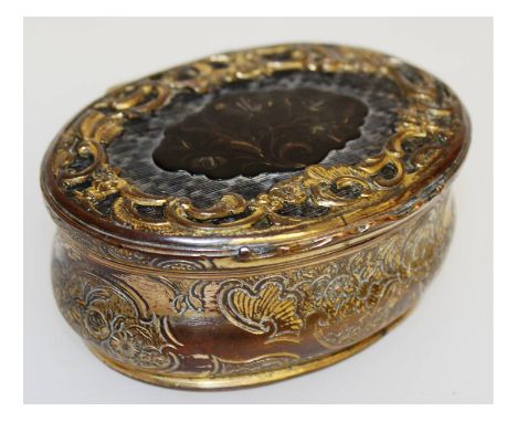 An 18th century continental gilt metal and tortoiseshell snuff box with scrolled and floral decoration. 8.5cms wide.