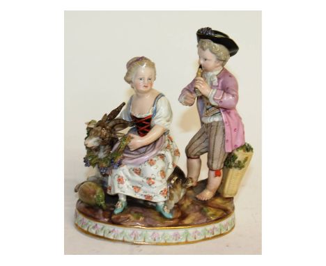 A Meissen group of a young boy playing a recorder, the girl seated at his side with a goat. Cross swords mark in blue. Faint 