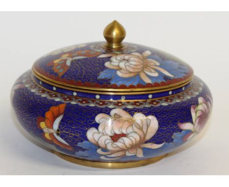 A blue Japanese cloisonne enamel circular bowl and cover, decorated with flowers. 6ins diameter.
