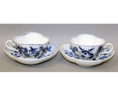 A pair of Meissen shaped blue and white onion pattern cups and saucers. Cross swords mark in blue.