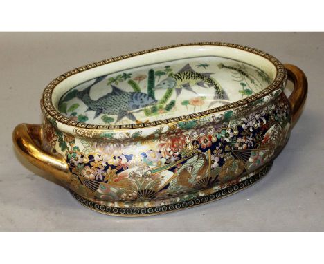 A Chinese Canton enamel design oval two handled jardiniere.  18ins long.