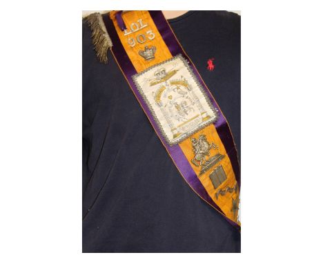 An Orange Orders Sash with badges.