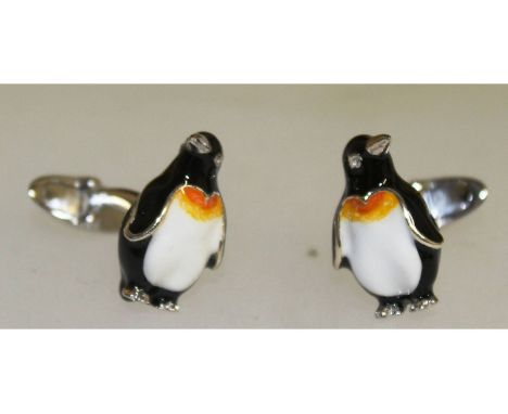 A pair of sterling silver and enamel cufflinks in the form of penguins.