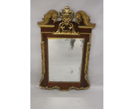 A good George II mahogany pier mirror, with carved and gilded scrolling broken arch pediment, leather and shell carved cresti