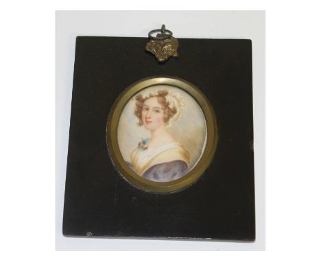 An oval portrait miniature of a young lady.