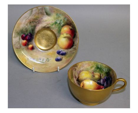 A Royal Worcester fruit painted teacup and saucer, both signed by Ricketts, puce mark.