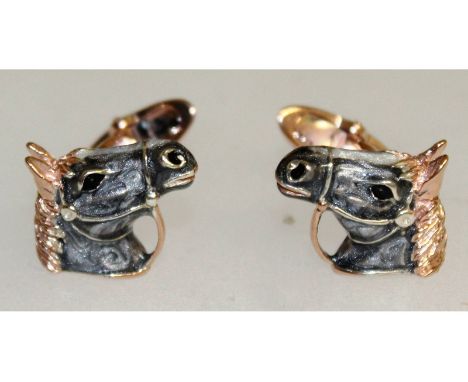 A pair of sterling silver and enamel cufflinks in the form of horses heads.