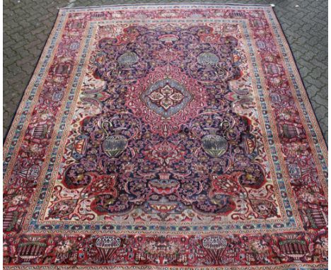 A good large Tabriz carpet, blue ground with urn motifs within a red ground urn decorated border. 12ft 4ins x 9ft 8ins.