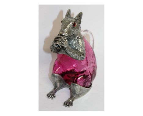 A ruby glass and plate squirrel claret jug with glass body. 7ins high.