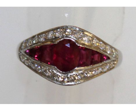 A ruby and diamond half hoop ring, set in 18ct white gold.